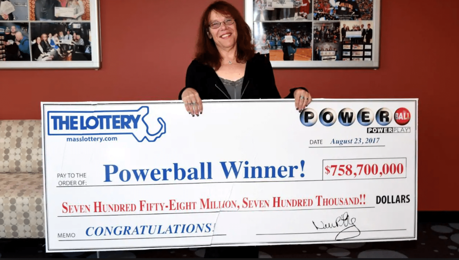 Maris Wanzcyk holding her cheque from The Lottery